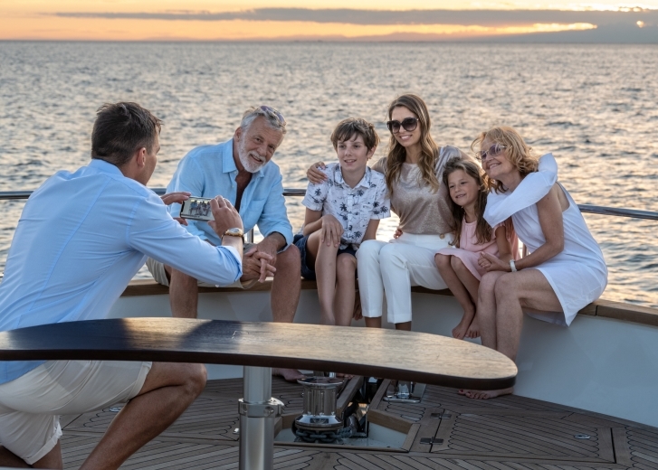 Family on a boat smiling for photo